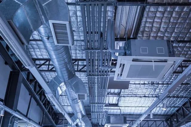 Commercial ductwork and HVAC systems inside a construction-ready space